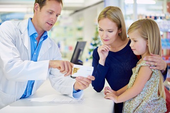Pharmacy, medicine and mom with child at counter for pills, medication and prescription order. Healthcare, drug store and pharmacist, mother and girl with tablets for wellness, health and treatment