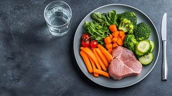 Healthy food clean eating concept. Raw meat with vegetables on dark background. Top view, copy space.